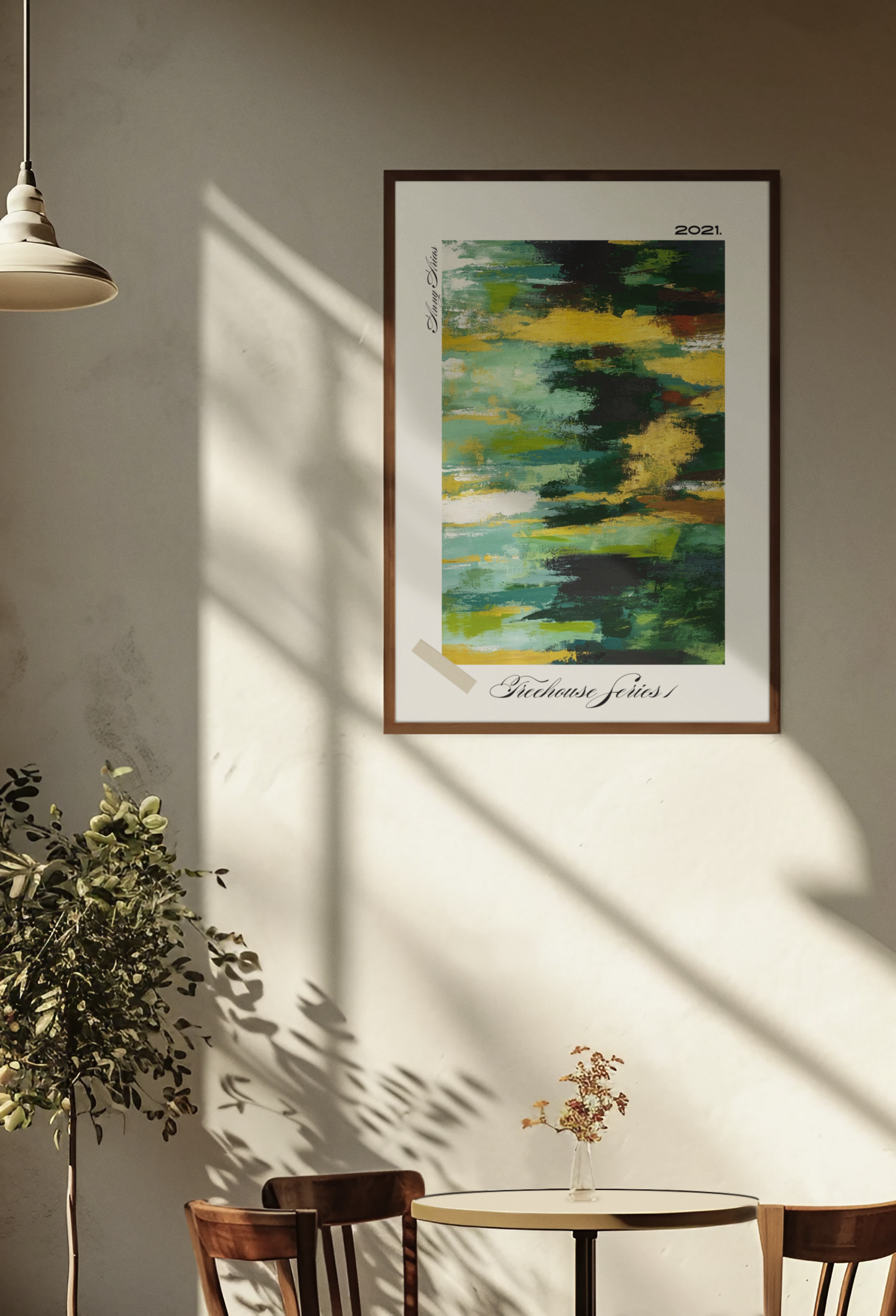 Framed abstract art on a wall with a table and chairs below